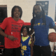 Bub Carrington, Aron Nwankwo, and Nwankwo's kid at a back-to-school event in Baltimore, Maryland.